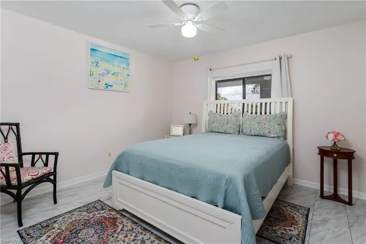 Bedroom 2 with vinyl flooring and ceiling fan