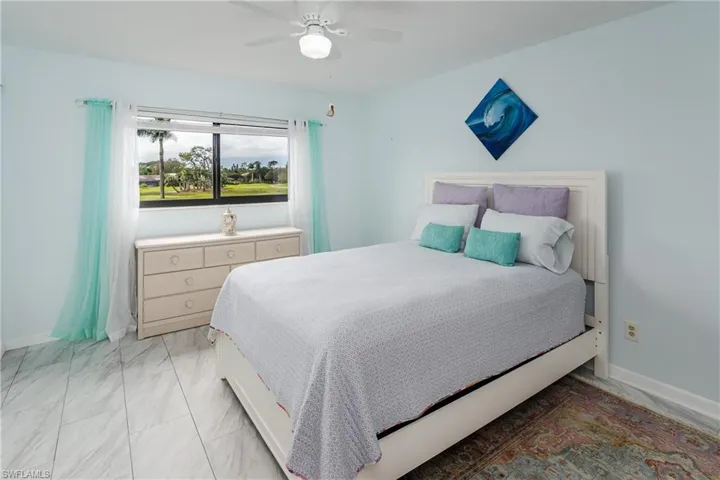 Bedroom ceiling fan, and sliding doors to the lanai