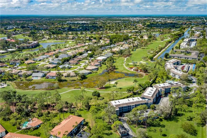 Birds eye view of property with a residential view, view of golf course, and a water view