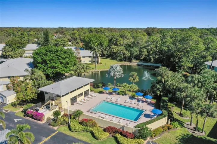Birds eye view of property with a water view