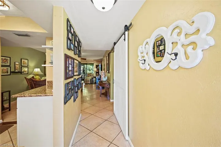 Hall featuring a barn door and light tile patterned flooring