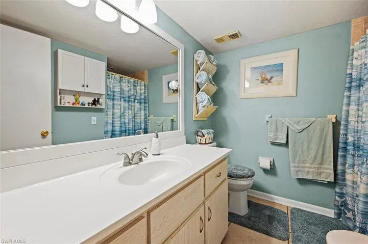 Bathroom featuring tile patterned floors, vanity, and toilet