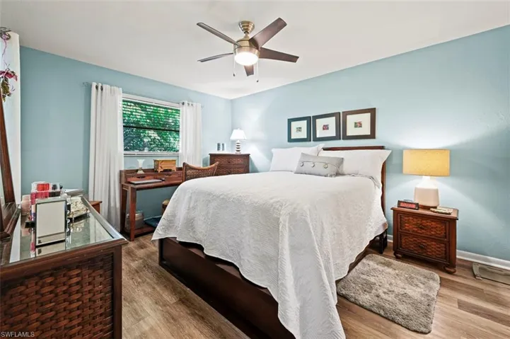 Bedroom featuring wood-type flooring and ceiling fan