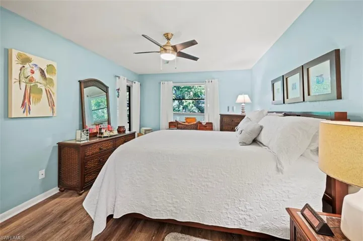 Bedroom featuring dark hardwood / wood-style floors and ceiling fan