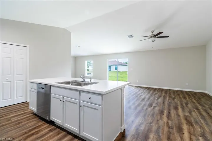 Unfurnished bedroom with dark wood-type flooring, a ceiling fan, and a closet