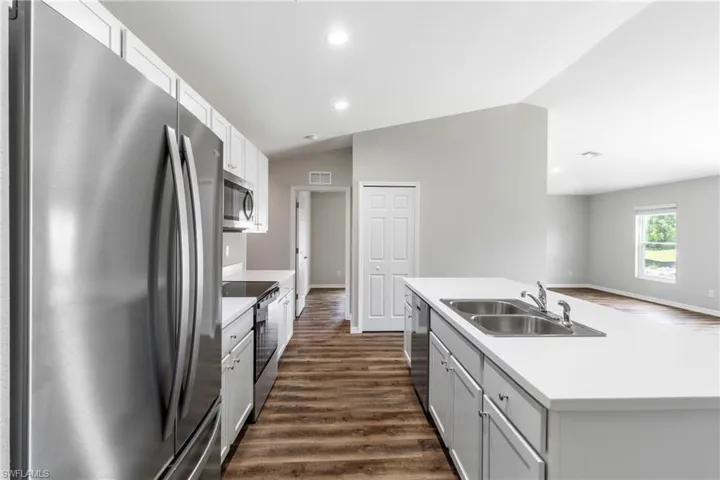 Spacious closet with dark wood-style flooring