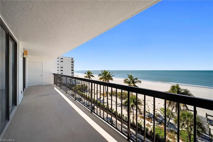 Balcony with view of water and beach