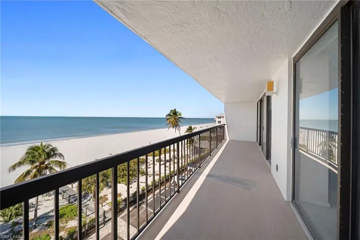 Balcony with view of water and beach