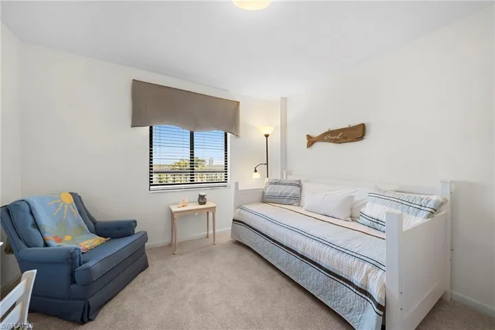 Bedroom with carpet flooring and baseboards