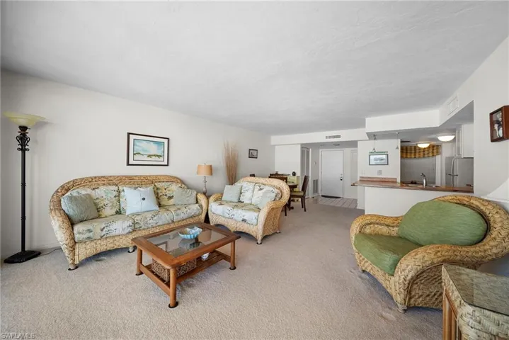Living area featuring light carpet