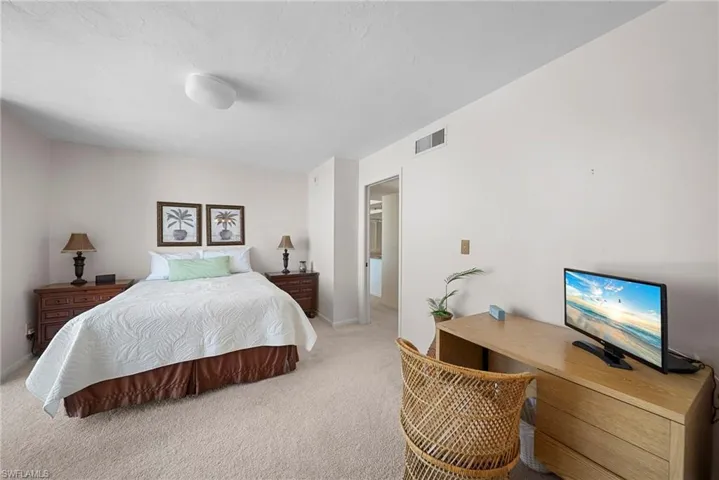 Bedroom with carpet flooring and baseboards
