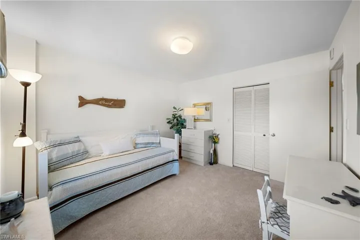 Bedroom featuring a closet and carpet flooring