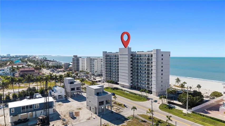 Aerial view of extended coastline and apartment complex / building