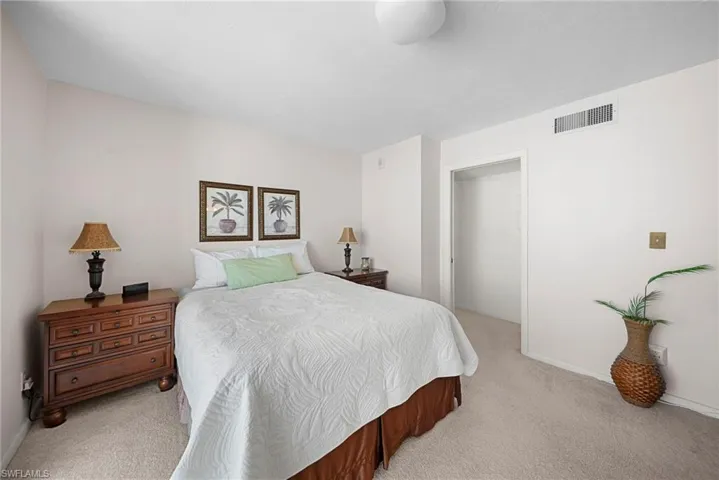Bedroom with baseboards and light carpet