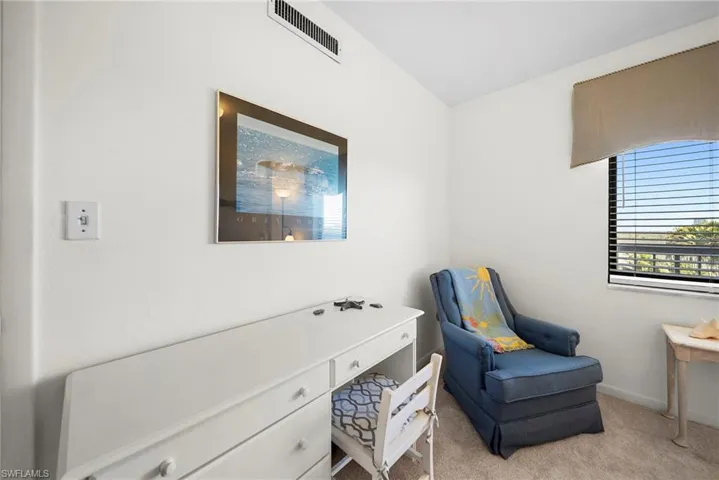 Living area with light carpet and baseboards