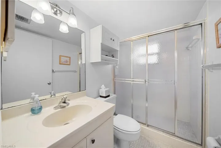 Full bathroom featuring a shower stall and vanity
