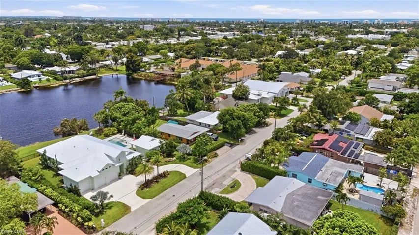 Expansive property featuring waterfront access, a private swimming pool, and lush landscaping