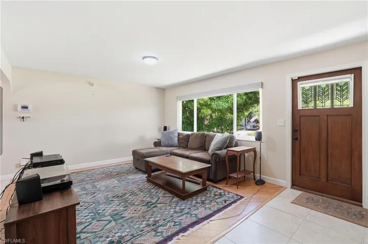 Entry area featuring a solid wood door with decorative glass paneling