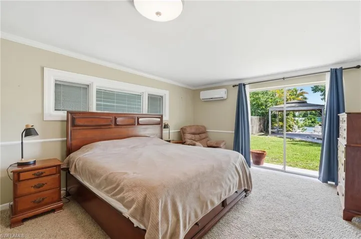 Bedroom featuring a large sliding glass door opening to outdoor space
