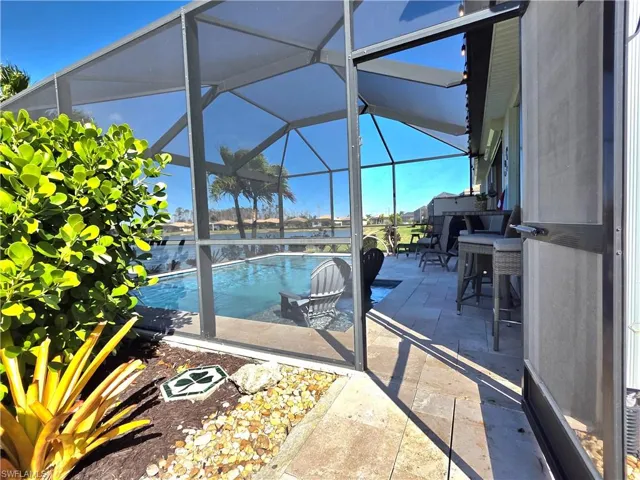 Swimming pool with a patio, a sunroom, and a lanai