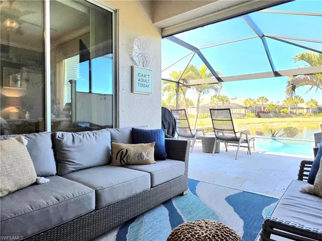 View of patio / terrace with outdoor furniture, a sunroom, an outdoor pool, and a grill