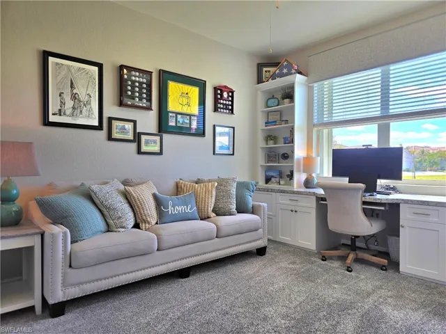 Home office with carpet floors and built in study area