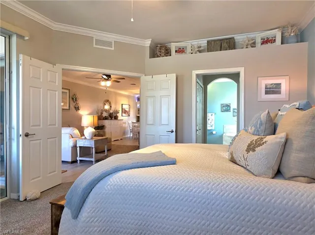 Carpeted bedroom featuring ornamental molding