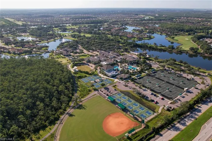 Aerial overview of property's location with a golf course and a nearby body of water