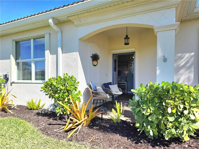 Doorway to property with stucco siding and a patio