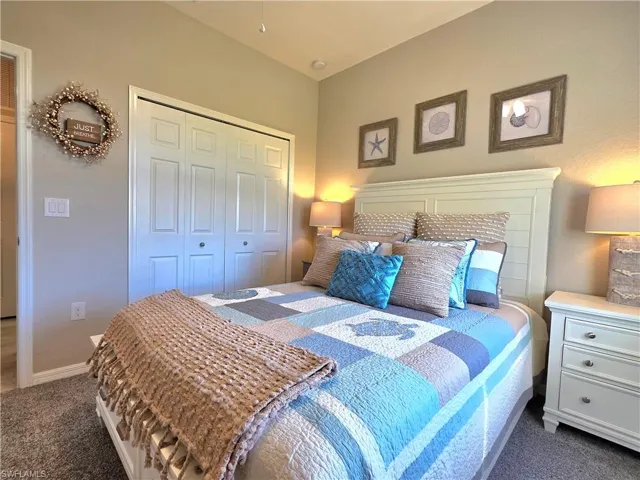 Bedroom featuring carpet flooring and a closet