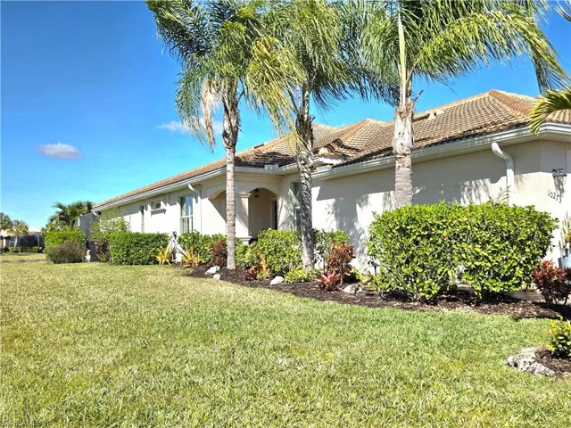 View of side of home featuring stucco siding and a yard