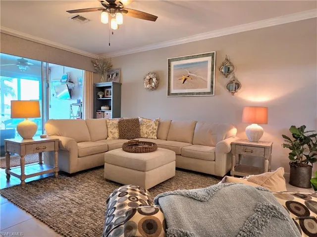 Living area featuring crown molding and ceiling fan