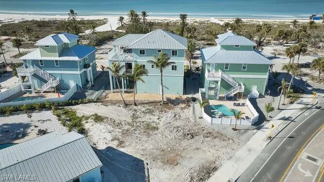 Drone / aerial view with a water view and a view of the beach