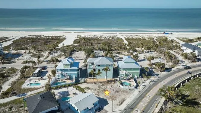 Bird's eye view with a water view and a view of the beach