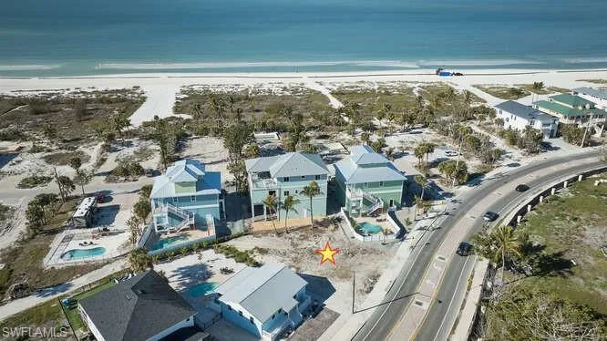 Drone / aerial view with a water view and a beach view