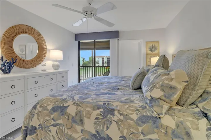 Bedroom with access to exterior and a ceiling fan