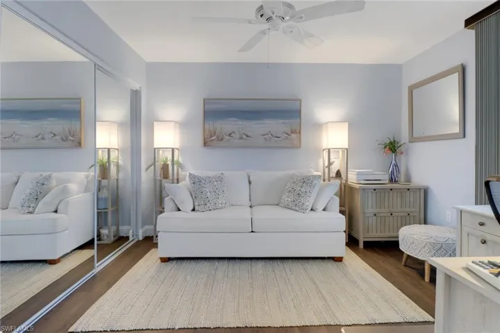 Living area with ceiling fan and wood finished floors