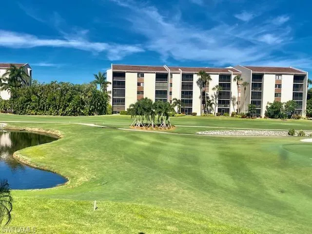View of property's community featuring a water view, golf course view, and a yard
