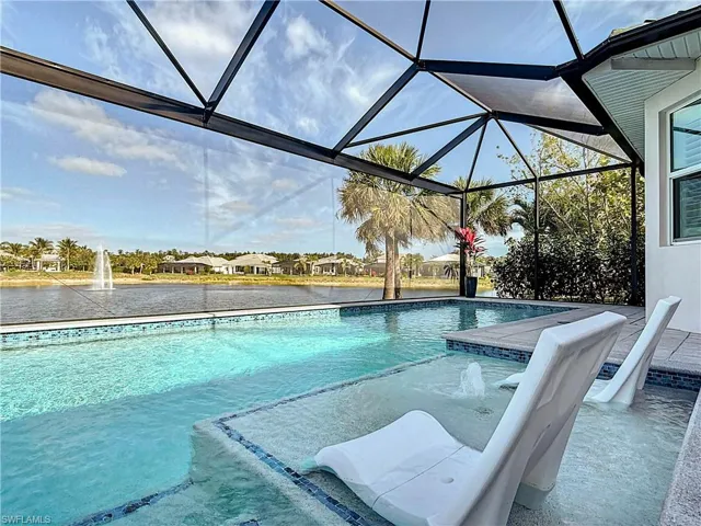 Outdoor custom pool featuring a screened lanai.