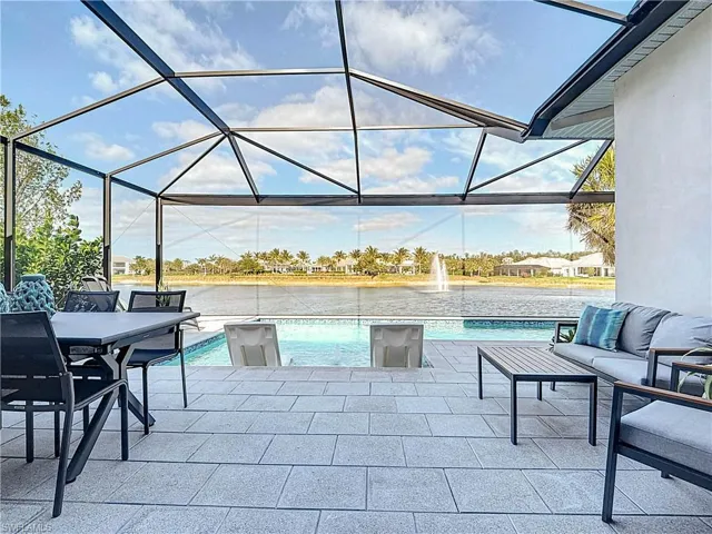 View of patio / terrace featuring a lanai, a  beautiful water view, and outdoor hangout area