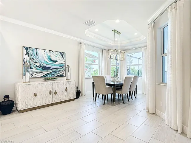 Dining area featuring recessed lighting, ,crown moldings, coffered ceilings and designer chandelier.