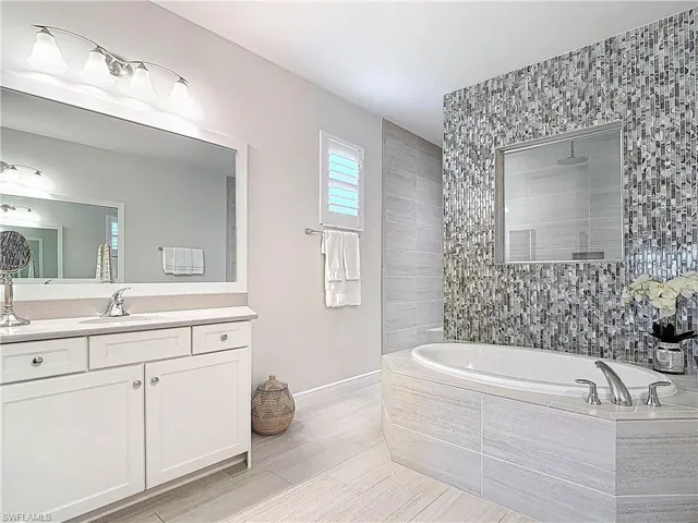 Bathroom with a soaking tub and large walk through shower.