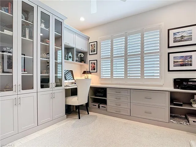 Home office featuring recessed lighting, built in desk and file cabinets with quartz countertops.