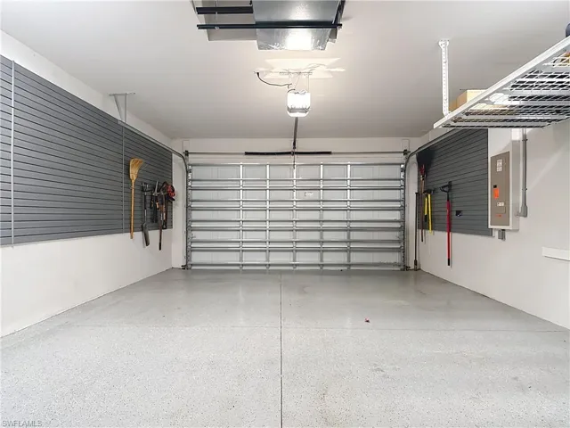 Expanded Garage with storage walls, overhead storage and cabinets.