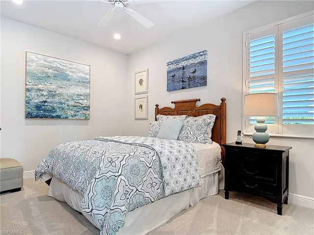 Expanded Carpeted guest bedroom with ceiling fan, recessed lighting and large closet with double wood shelves.