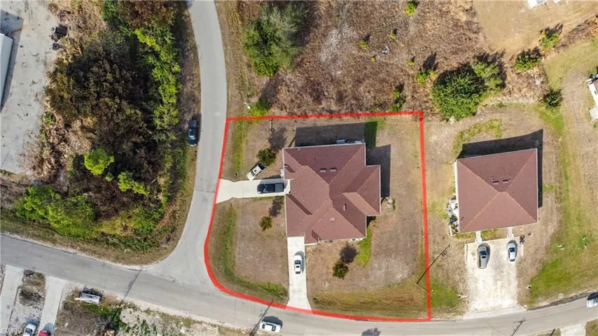 Aerial view of property and surrounding area featuring property parcel outlined