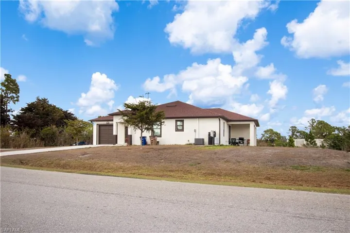 Mediterranean / spanish-style house featuring stucco siding, an attached garage, and driveway