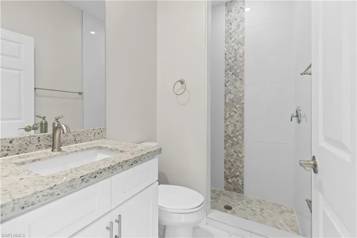 Full bath with vanity and tiled shower