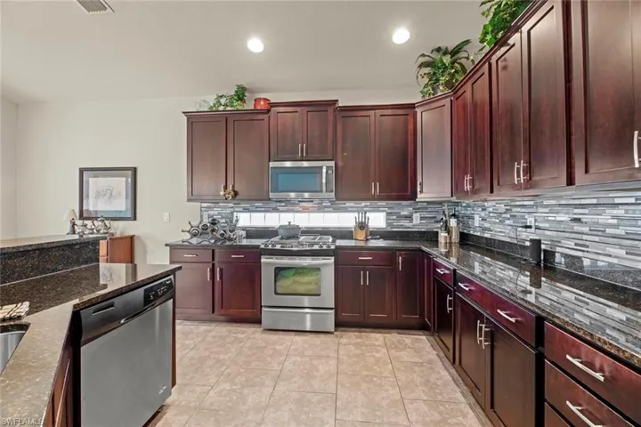 Kitchen w/granite countertops and glass backsplash