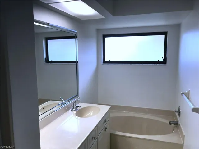 Bathroom with vanity and a bath